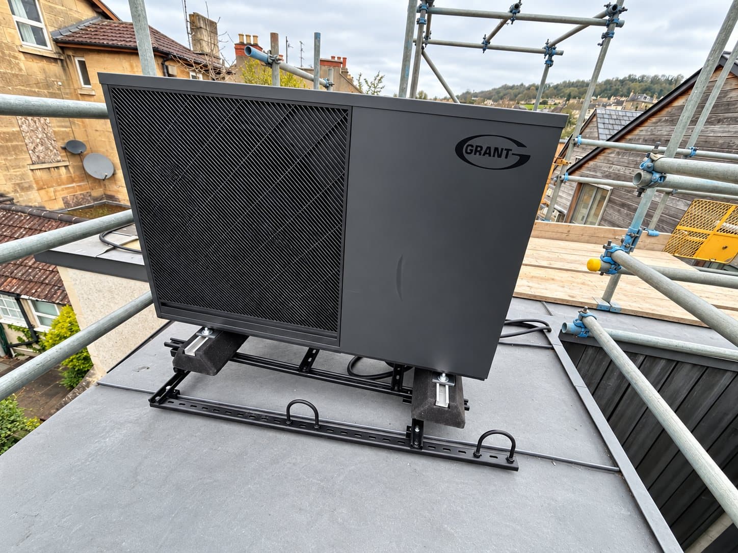 A Grant air source heat pump installed on a flat roof in Bath